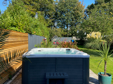 Load image into Gallery viewer, MAJORCA (USED) - This 6 seater family tub has 1 lounger, 1 massage pod and mounted Bluetooth speakers